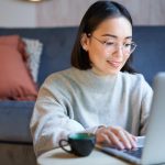 atinatin-portrait-smiling-asian-girl-working-from-home-staying-remote-using-laptop-studying-her-comp_1258-139531