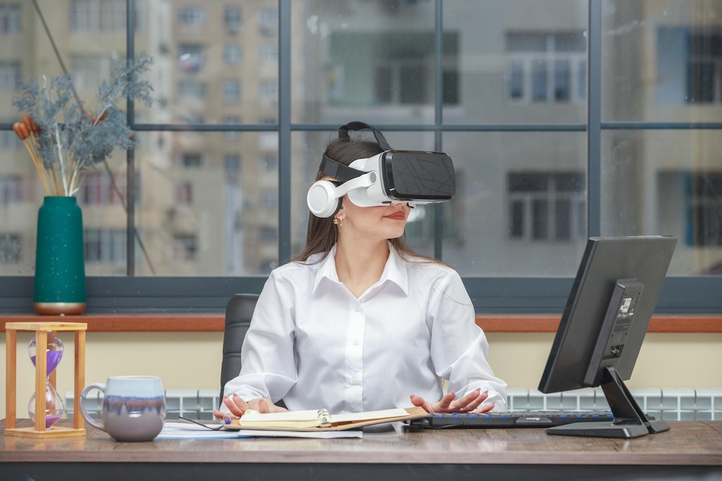 atbp-young-lady-sitting-desk-wearing-vr-glasses-while-looking-aside-high-quality-photo_144627-74946
